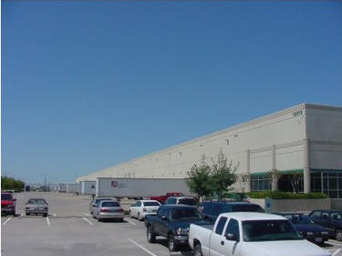 Prologis Timeline - 1991 A truck court and parking lot behind an AMB building