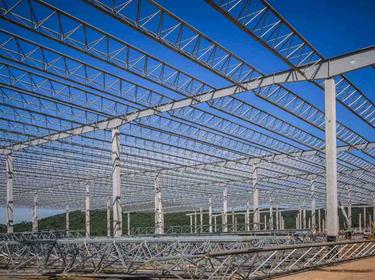 Prologis Timeline - 2004 Metal framing for a warehouse under construction with blue sky above