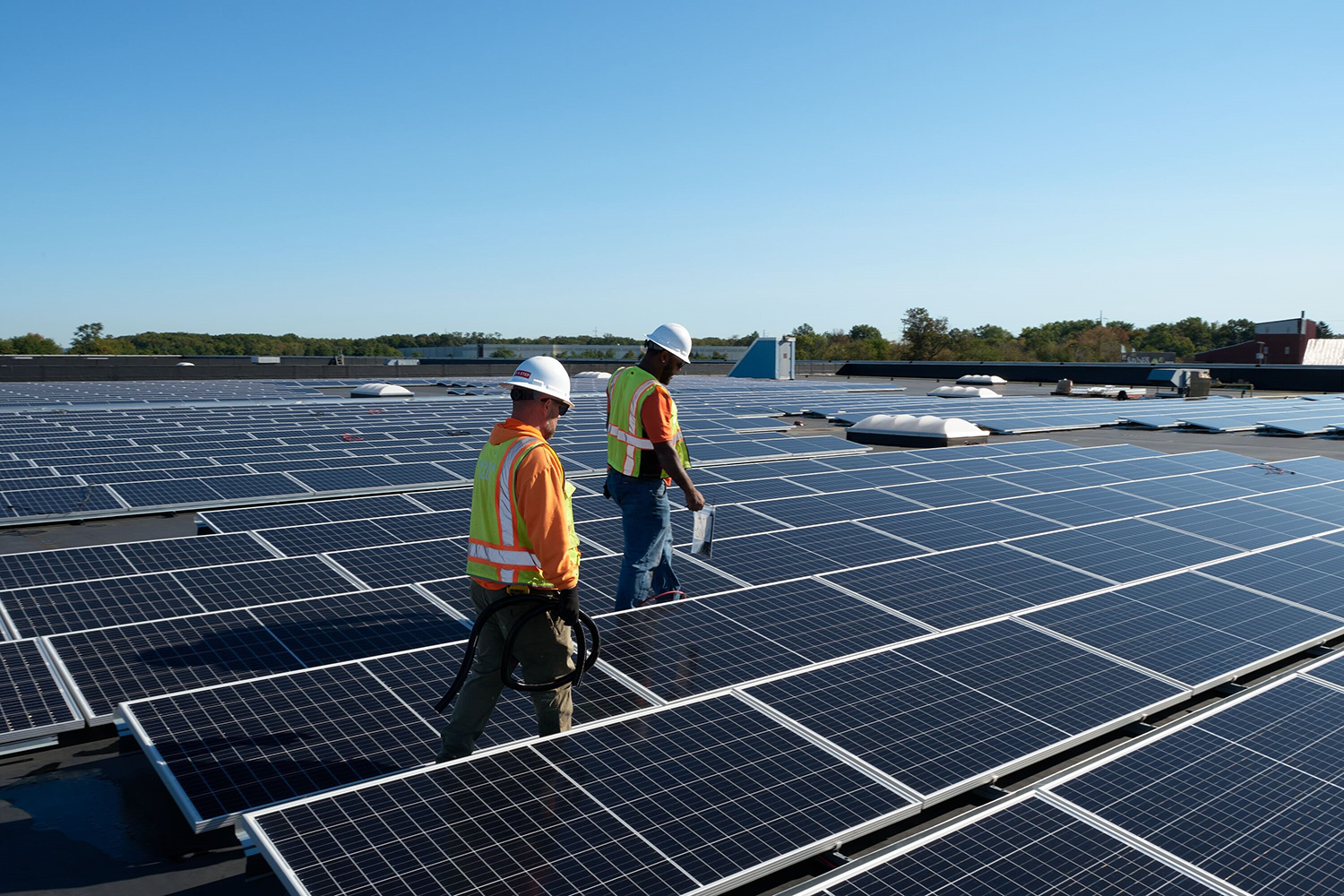 Large-Cranbury-0210.jpg Workers on roof of warehouse with Solar panels